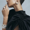 Bold silver jewellery and black partydress
