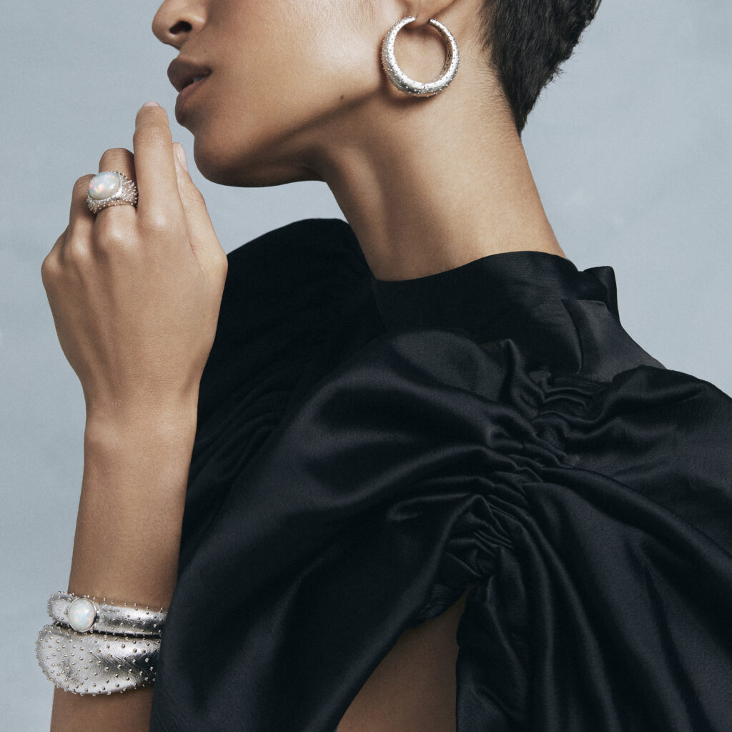 Bold silver jewellery and black partydress