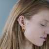 A blond woman wearing gold earrings